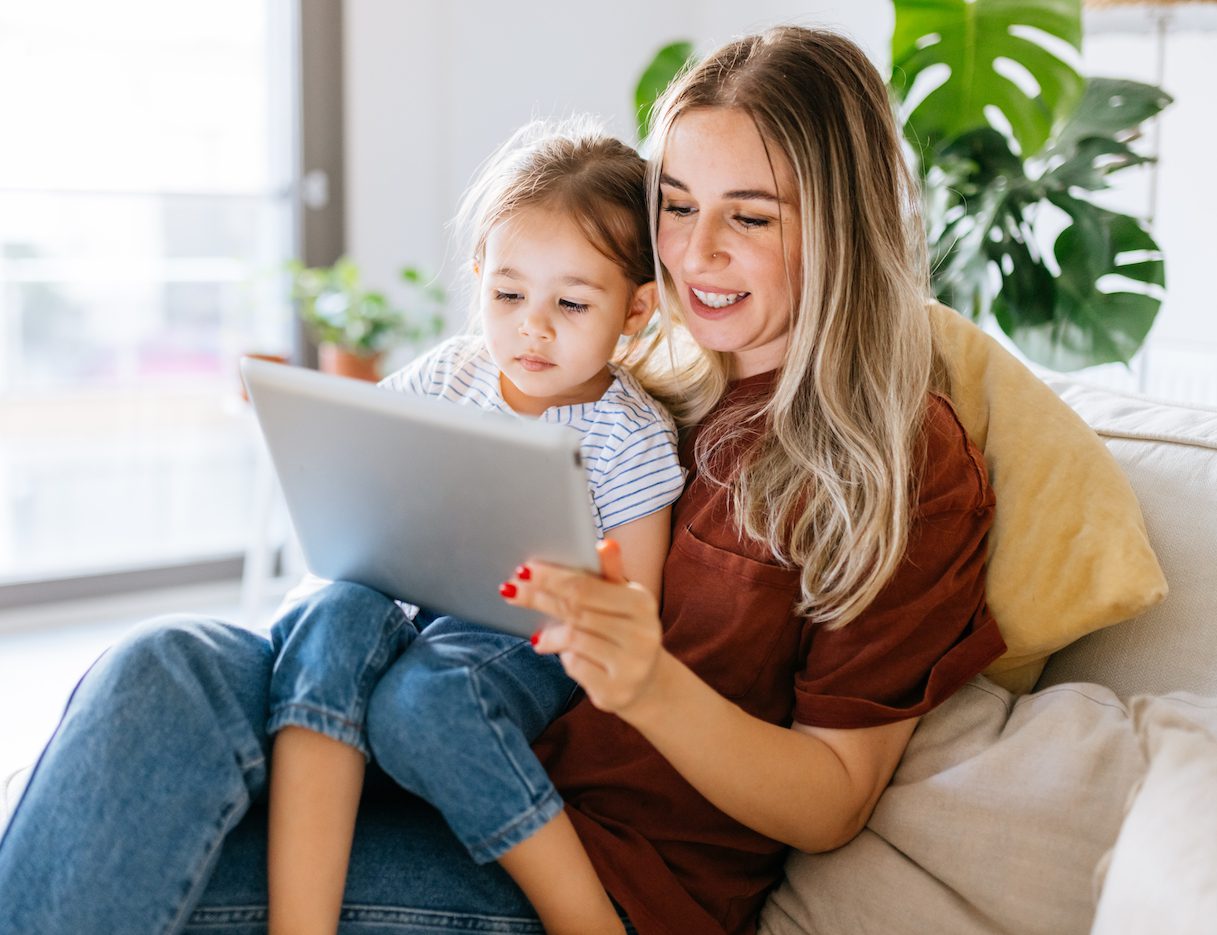 Mother and daughter using a digital tablet together