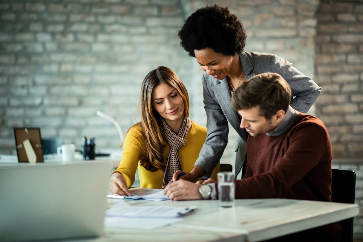 Couple analyzing their investment plans with insurance agent in the office