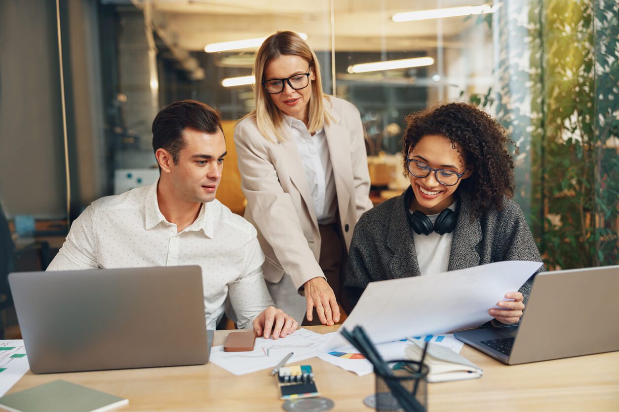 Group of business colleagues working together on project in modern coworking