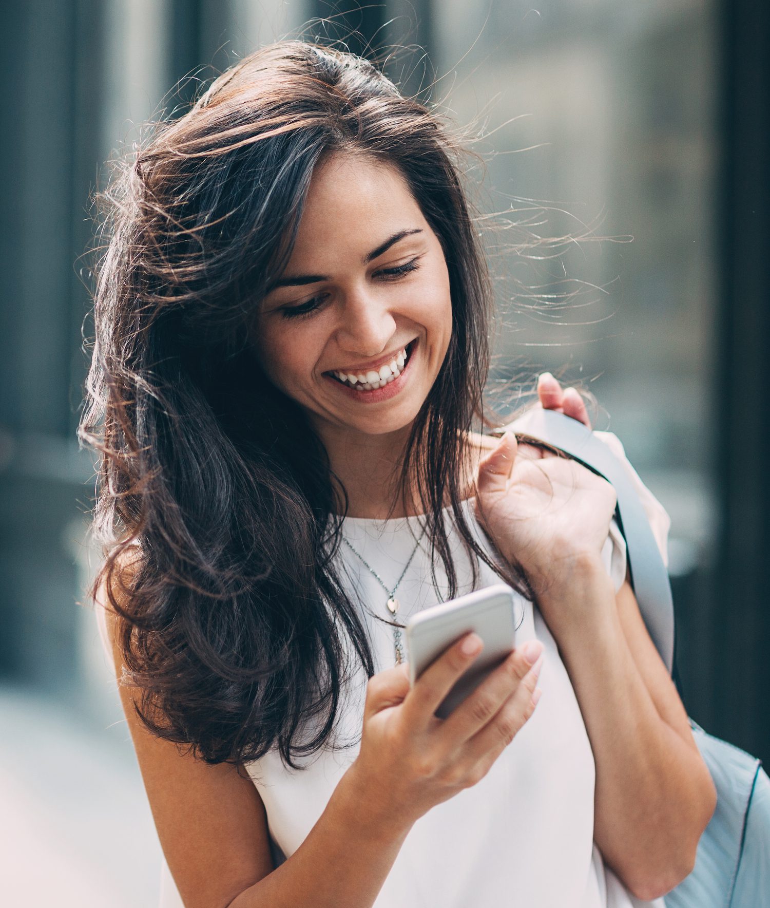 Beautiful woman texting on the street